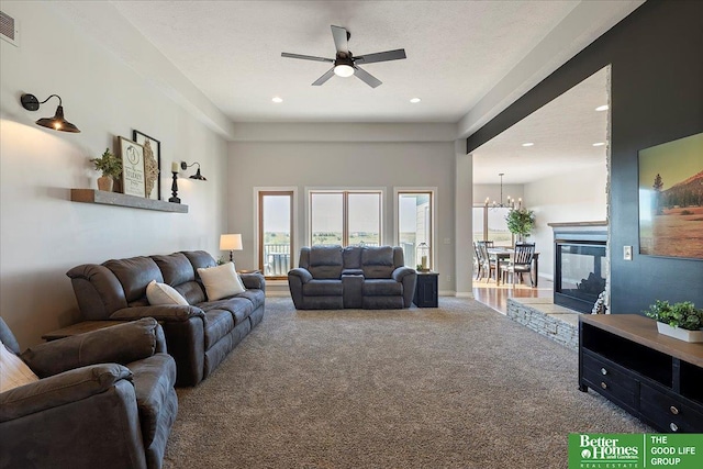 27896 Chestnut Rd, Treynor, IA 51575 - carpeted living room featuring a ceiling fan, a chandelier, and recessed lighting