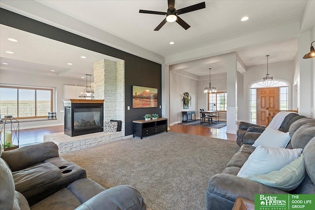 27896 Chestnut Rd, Treynor, IA 51575 - living room featuring healthy amount of natural light, recessed lighting, ceiling fan, a chandelier, and a fireplace