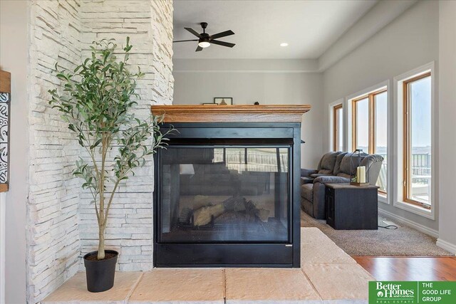 27896 Chestnut Rd, Treynor, IA 51575 - detailed view of a multi sided fireplace, a ceiling fan, and wood finished floors
