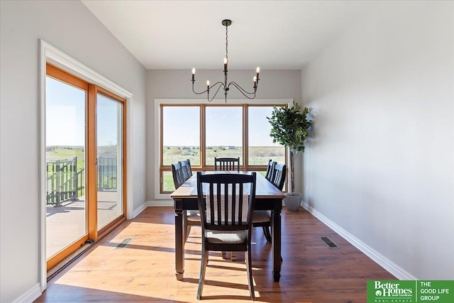 27896 Chestnut Rd, Treynor, IA 51575 - dining area with a chandelier, wood finished floors, and baseboards