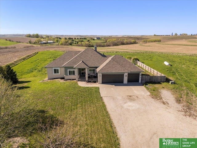 27896 Chestnut Rd, Treynor, IA 51575 - view of front of home featuring concrete driveway, an attached garage, a front yard, and a view of rural / pastoral area