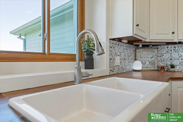 27896 Chestnut Rd, Treynor, IA 51575 - kitchen view of a sink, white cabinets, and decorative backsplash