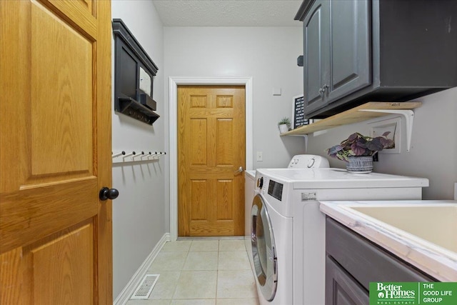 27896 Chestnut Rd, Treynor, IA 51575 - laundry room with separate washer and dryer, cabinet space, light tile patterned floors, and baseboards