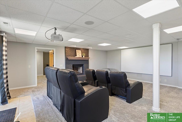27896 Chestnut Rd, Treynor, IA 51575 - home theater room featuring carpet flooring, a drop ceiling, a fireplace, and baseboards