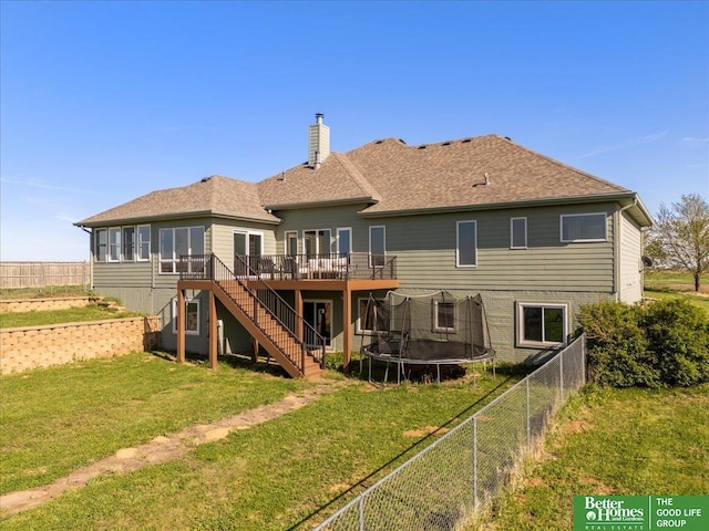 27896 Chestnut Rd, Treynor, IA 51575 - rear view of house featuring stairway, a wooden deck, a chimney, a trampoline, and a shingled roof