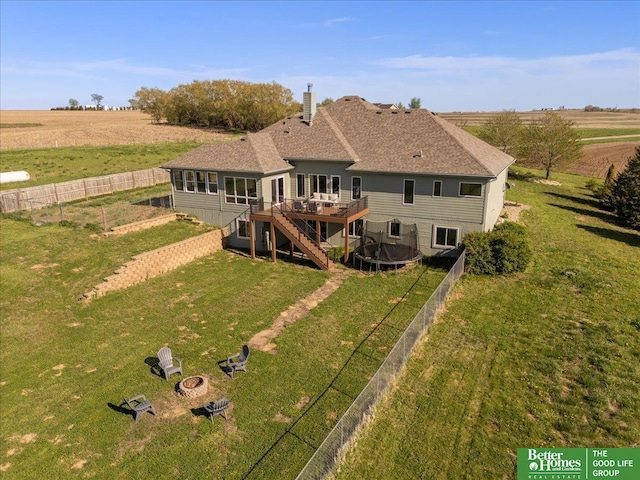 27896 Chestnut Rd, Treynor, IA 51575 - back of house featuring a deck, an outdoor fire pit, stairs, a trampoline, and a chimney