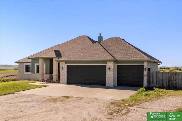 27896 Chestnut Rd, Treynor, IA 51575 - view of front of property with brick siding, an attached garage, concrete driveway, roof with shingles, and a chimney