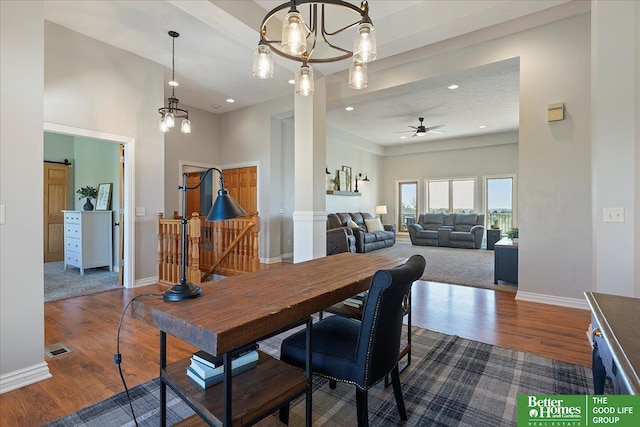 27896 Chestnut Rd, Treynor, IA 51575 - dining area featuring dark wood finished floors, ceiling fan, baseboards, recessed lighting, and a barn door