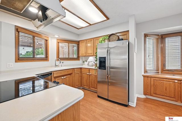 12231 Binney St, Omaha, NE 68164 - kitchen featuring stainless steel fridge with ice dispenser, light wood-style floors, a sink, light countertops, and brown cabinetry
