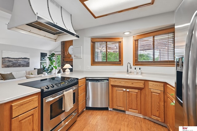 12231 Binney St, Omaha, NE 68164 - kitchen featuring stainless steel appliances, a sink, under cabinet range hood, light wood-style floors, and open floor plan