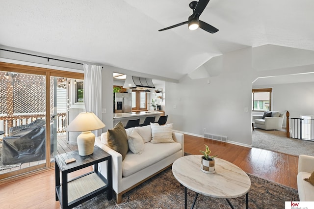 12231 Binney St, Omaha, NE 68164 - living area featuring ceiling fan, wood finished floors, lofted ceiling, and baseboards