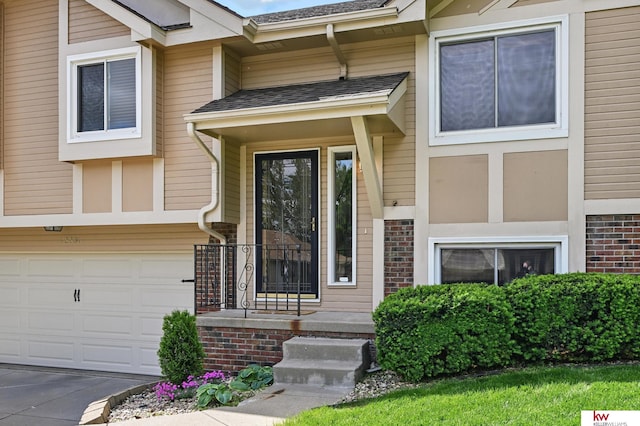 12231 Binney St, Omaha, NE 68164 - doorway to property with an attached garage, concrete driveway, and a shingled roof