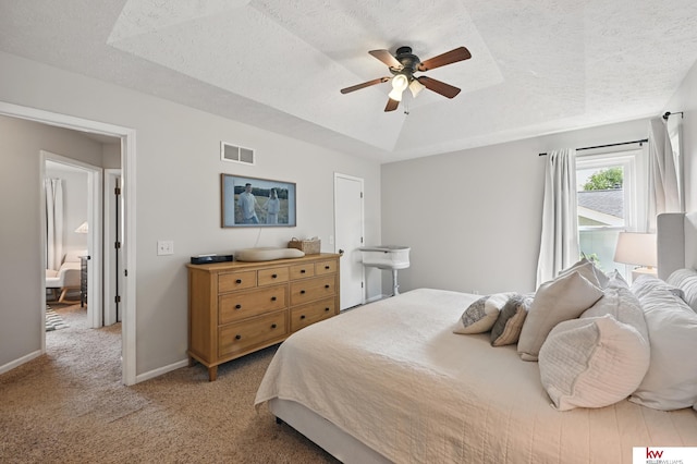 12231 Binney St, Omaha, NE 68164 - bedroom with a textured ceiling, a tray ceiling, light carpet, baseboards, and a ceiling fan