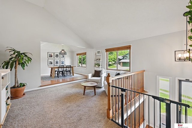 12231 Binney St, Omaha, NE 68164 - carpeted living room featuring high vaulted ceiling, baseboards, and a chandelier