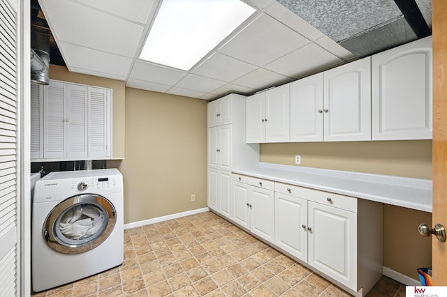 12231 Binney St, Omaha, NE 68164 - laundry room featuring washer / dryer, cabinet space, and baseboards