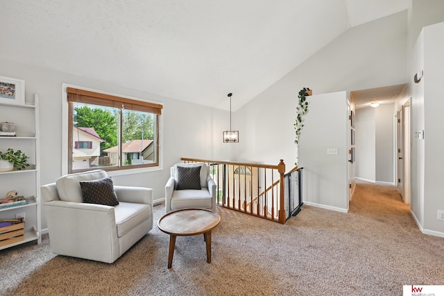 12231 Binney St, Omaha, NE 68164 - living area featuring an upstairs landing, carpet flooring, high vaulted ceiling, baseboards, and a chandelier