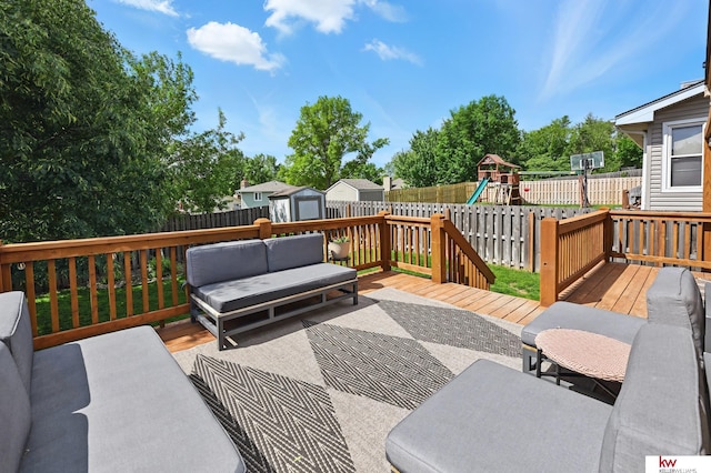 12231 Binney St, Omaha, NE 68164 - deck featuring a fenced backyard, a playground, and an outdoor hangout area