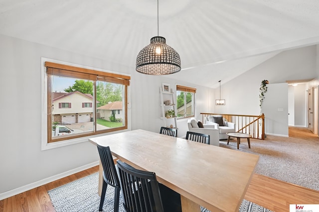 12231 Binney St, Omaha, NE 68164 - dining room featuring vaulted ceiling, a chandelier, baseboards, and wood finished floors
