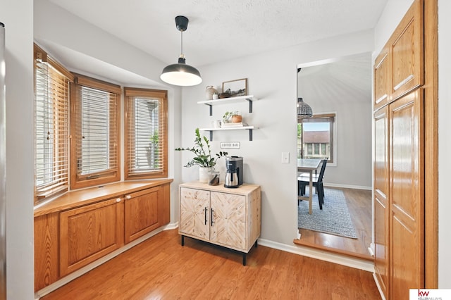 12231 Binney St, Omaha, NE 68164 - dining space with light wood finished floors, baseboards, and a textured ceiling