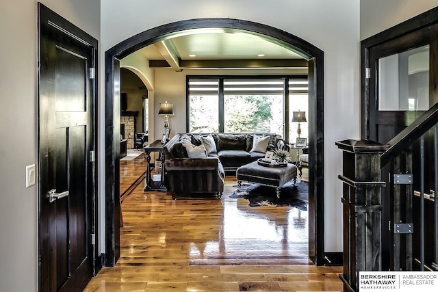 3334 S 188th Ave, Omaha, NE 68130 - living room featuring arched walkways, wood finished floors, and a fireplace