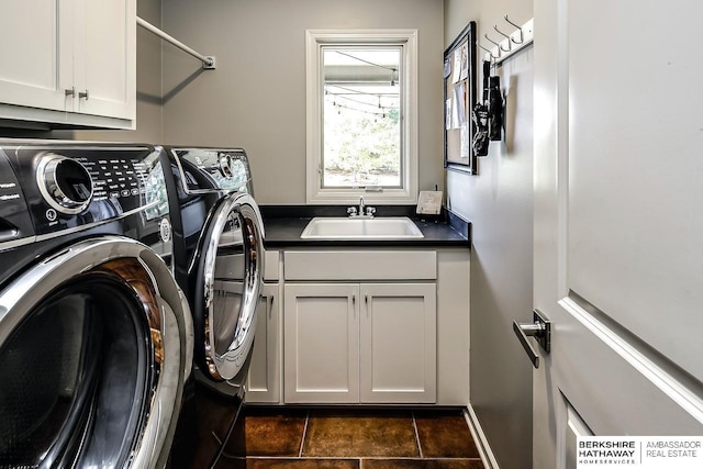 3334 S 188th Ave, Omaha, NE 68130 - laundry room featuring washing machine and dryer, cabinet space, and dark tile patterned floors