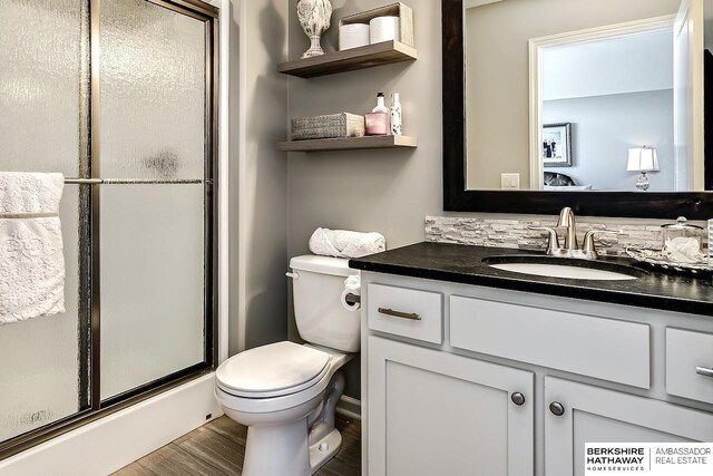 3334 S 188th Ave, Omaha, NE 68130 - full bathroom with a shower stall, vanity, toilet, and wood finished floors