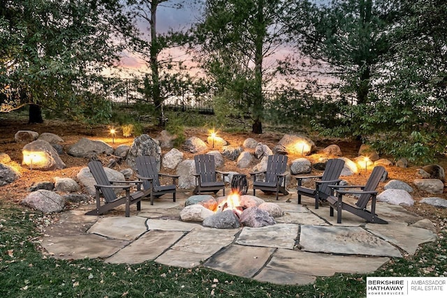 3334 S 188th Ave, Omaha, NE 68130 - patio terrace at dusk featuring an outdoor fire pit and a patio