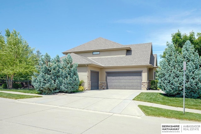 3334 S 188th Ave, Omaha, NE 68130 - view of front of home with concrete driveway, a garage, roof with shingles, and stone siding