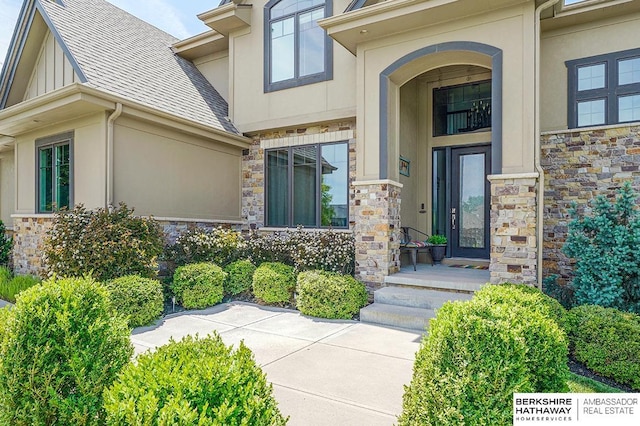 3334 S 188th Ave, Omaha, NE 68130 - property entrance featuring stone siding, stucco siding, and a shingled roof