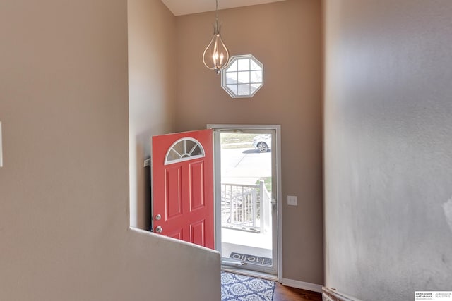 6704 N 149th Ave, Omaha, NE 68116 - foyer entrance with a chandelier, wood finished floors, and baseboards