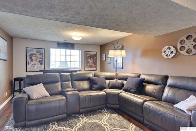 6704 N 149th Ave, Omaha, NE 68116 - living area featuring wood finished floors, a textured ceiling, and baseboards