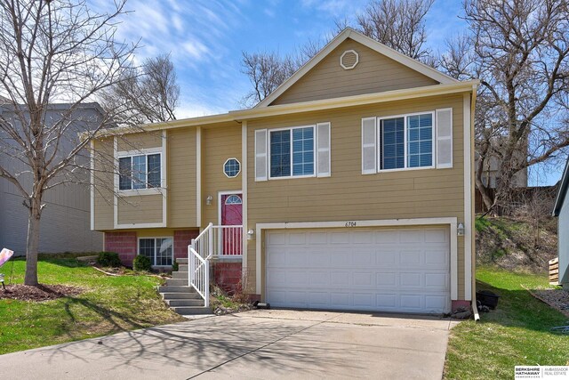 6704 N 149th Ave, Omaha, NE 68116 - raised ranch with an attached garage, concrete driveway, and a front lawn
