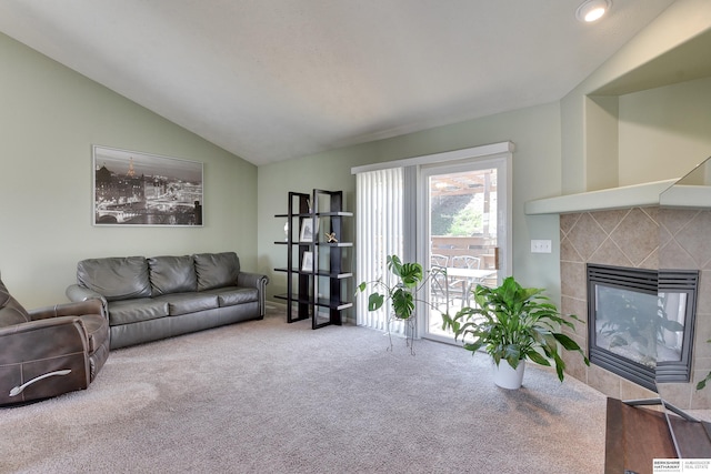 6704 N 149th Ave, Omaha, NE 68116 - carpeted living room featuring a tile fireplace and lofted ceiling