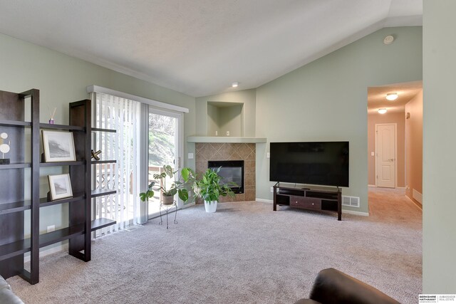 6704 N 149th Ave, Omaha, NE 68116 - carpeted living room with lofted ceiling, a tile fireplace, and baseboards