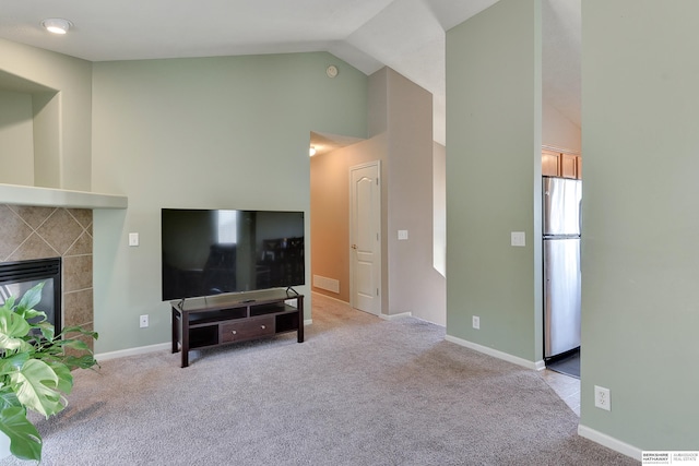6704 N 149th Ave, Omaha, NE 68116 - living area featuring carpet floors, high vaulted ceiling, a tiled fireplace, and baseboards