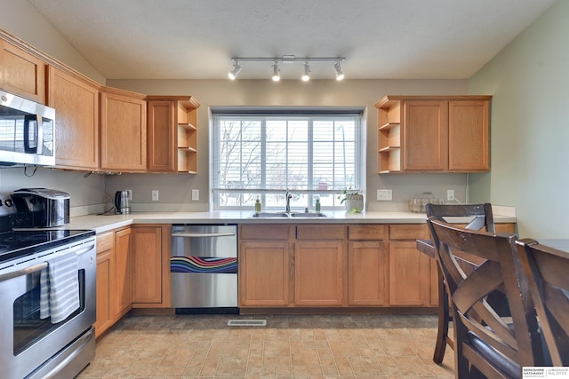 6704 N 149th Ave, Omaha, NE 68116 - kitchen with appliances with stainless steel finishes, open shelves, a sink, and light countertops