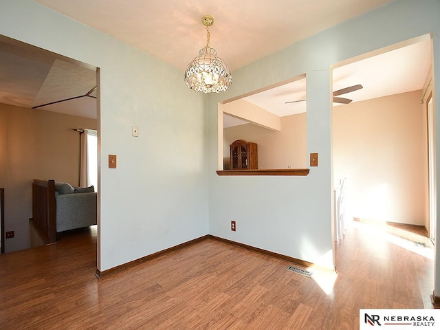 6115 S 115th St, Omaha, NE 68137 - empty room with wood finished floors and a chandelier
