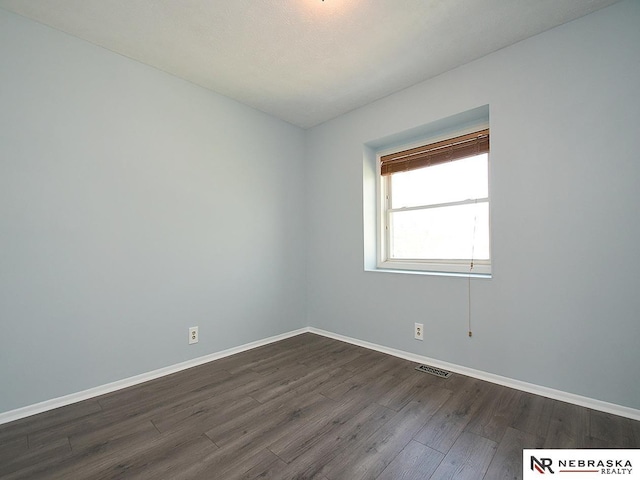 6115 S 115th St, Omaha, NE 68137 - empty room featuring dark wood-type flooring and baseboards