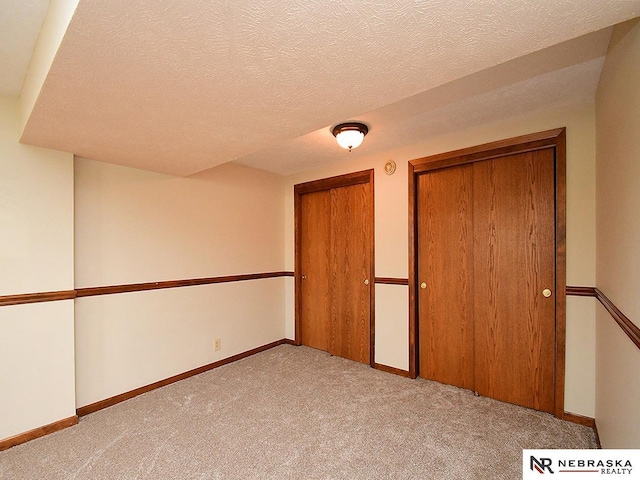6115 S 115th St, Omaha, NE 68137 - unfurnished bedroom featuring light carpet, baseboards, and a textured ceiling