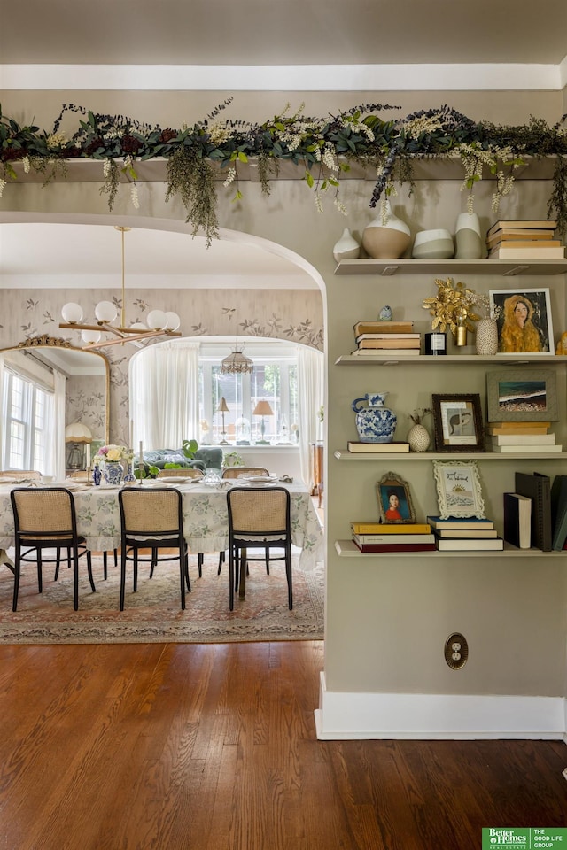 5147 Davenport St, Omaha, NE 68132 - dining room featuring a chandelier, wood finished floors, and arched walkways