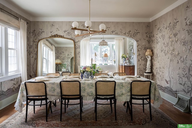 5147 Davenport St, Omaha, NE 68132 - dining room with wood finished floors, a chandelier, wallpapered walls, and baseboards