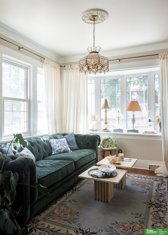 5147 Davenport St, Omaha, NE 68132 - living area with healthy amount of natural light, wood finished floors, and ornamental molding