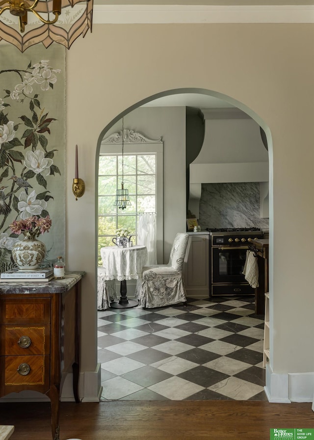 5147 Davenport St, Omaha, NE 68132 - corridor featuring arched walkways, dark floors, and a chandelier