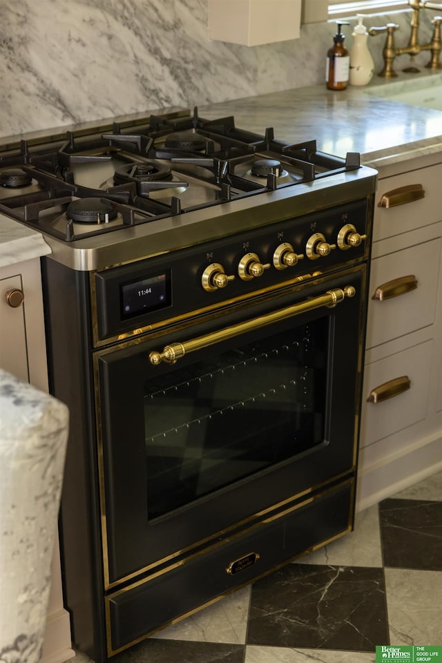 5147 Davenport St, Omaha, NE 68132 - detailed view of gas stove, light countertops, and tasteful backsplash