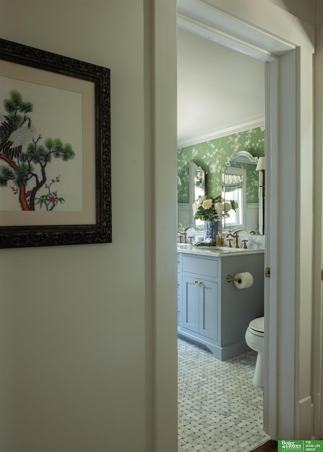 5147 Davenport St, Omaha, NE 68132 - bathroom with wallpapered walls, vanity, toilet, and crown molding