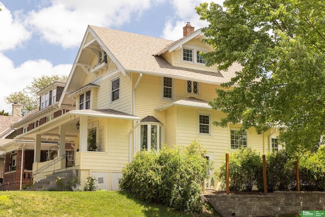 5147 Davenport St, Omaha, NE 68132 - view of home's exterior with a shingled roof, a chimney, and a lawn