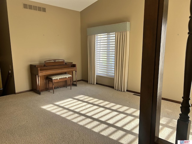 5418 Thies Cove Dr, Lincoln, NE 68516 - living area featuring carpet floors, baseboards, and vaulted ceiling