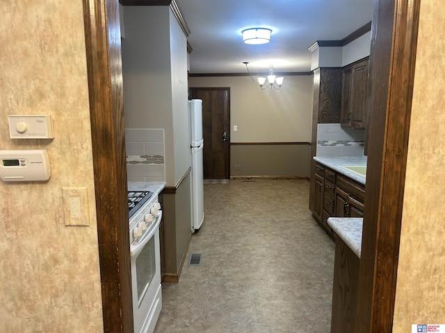 5418 Thies Cove Dr, Lincoln, NE 68516 - kitchen featuring white appliances, tile patterned floors, ornamental molding, light countertops, and dark brown cabinets