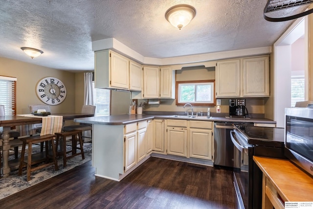 605 2nd St, Waterloo, NE 68069 - kitchen featuring black electric range oven, a sink, a textured ceiling, dark wood-type flooring, and a peninsula