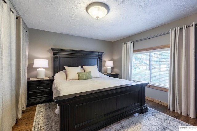 605 2nd St, Waterloo, NE 68069 - bedroom with a textured ceiling, wood finished floors, and baseboards